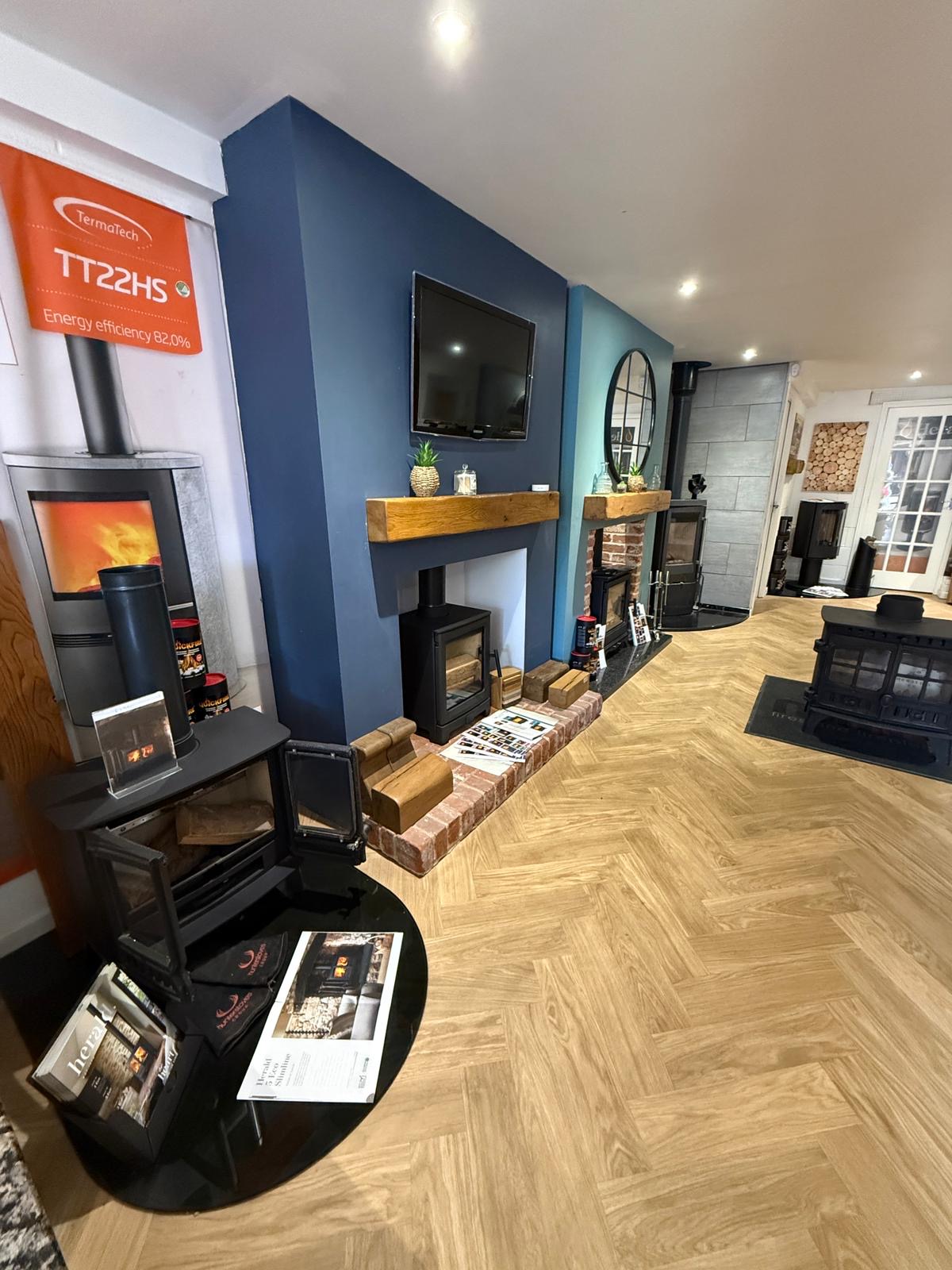 A wide view down the showroom showing the TermaTech display and the stove range.